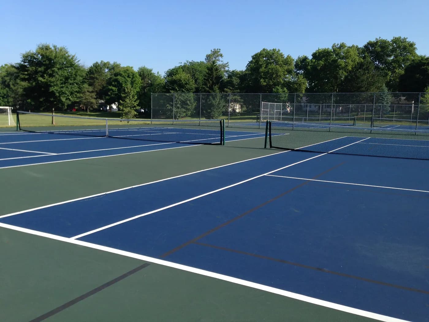 Blue and green public tennis courts in an Upper Arlington park